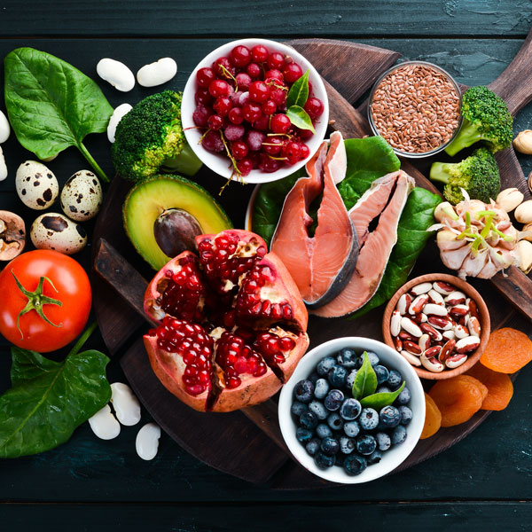 Overhead view of fresh produce, fish, nuts and berries
